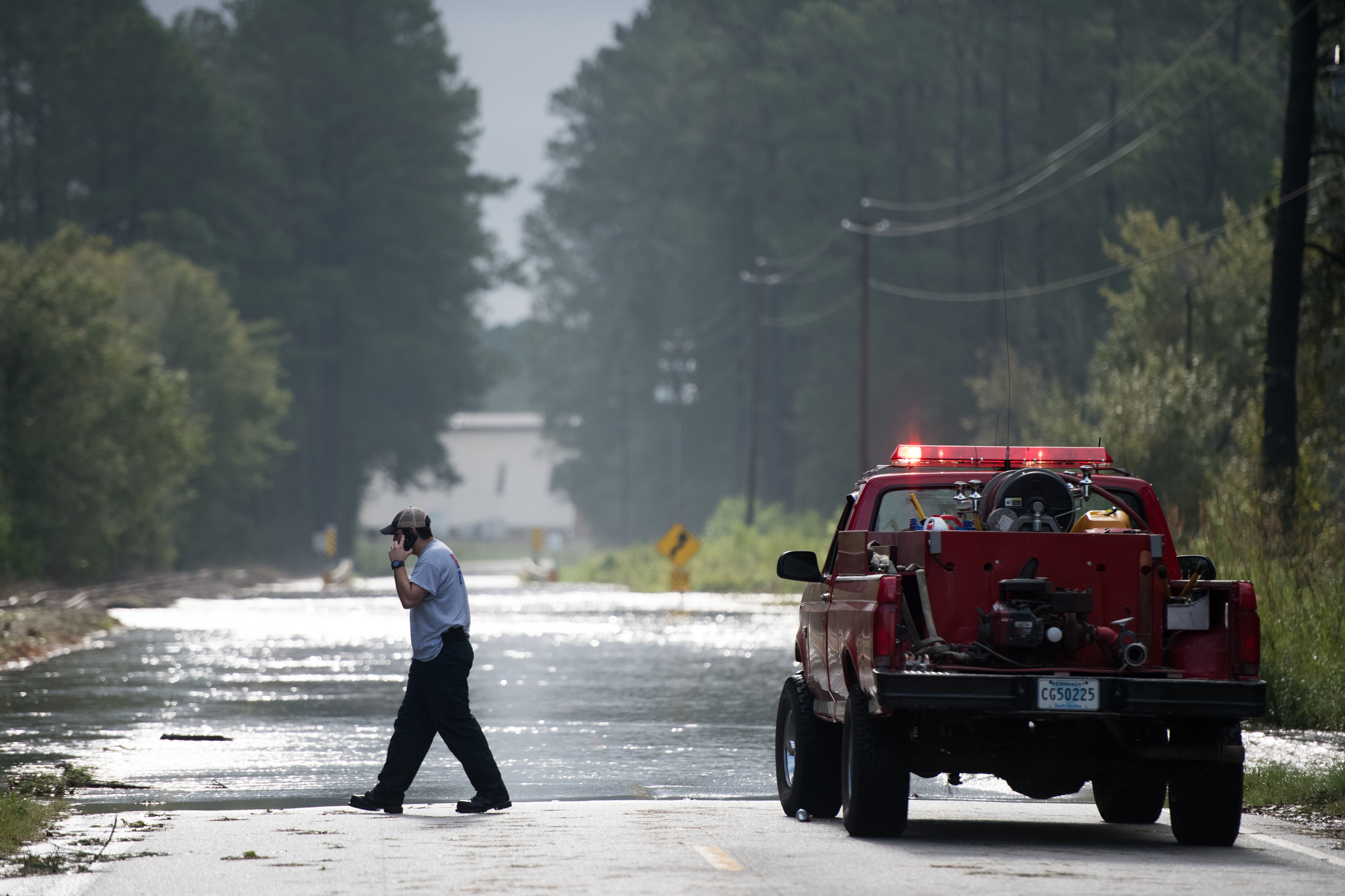 Wallace firefighter A.J. Jackson explores a flooded road after Hurricane Florence struck the Carolinas September 17, 2018, in Wallace, South Carolina. (Credit: Sean Rayford/Getty Images)