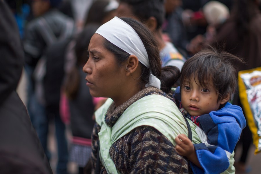 Members of a caravan of Central Americans who spent weeks traveling across Mexico walk from Mexico to the U.S. side of the border to ask authorities for asylum on April 29, 2018, in Tijuana, Baja California Norte, Mexico. (Credit: David McNew/Getty Images)