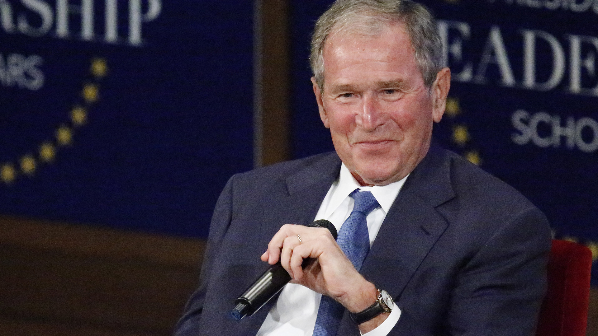 Former U.S. President George W. Bush responds with a smile after making a joke while answering a question at the Presidential Leadership Scholars graduation ceremony at the George W. Bush Institute on July 13, 2017, in Dallas, Texas. (Credit: Stewart F. House/Getty Images)