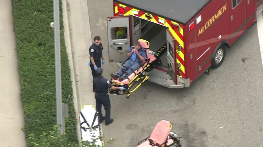 Fire officials transport a patient who became sickened after a workplace luncheon in El Segundo on Sept. 5, 2018. (Credit: KTLA)