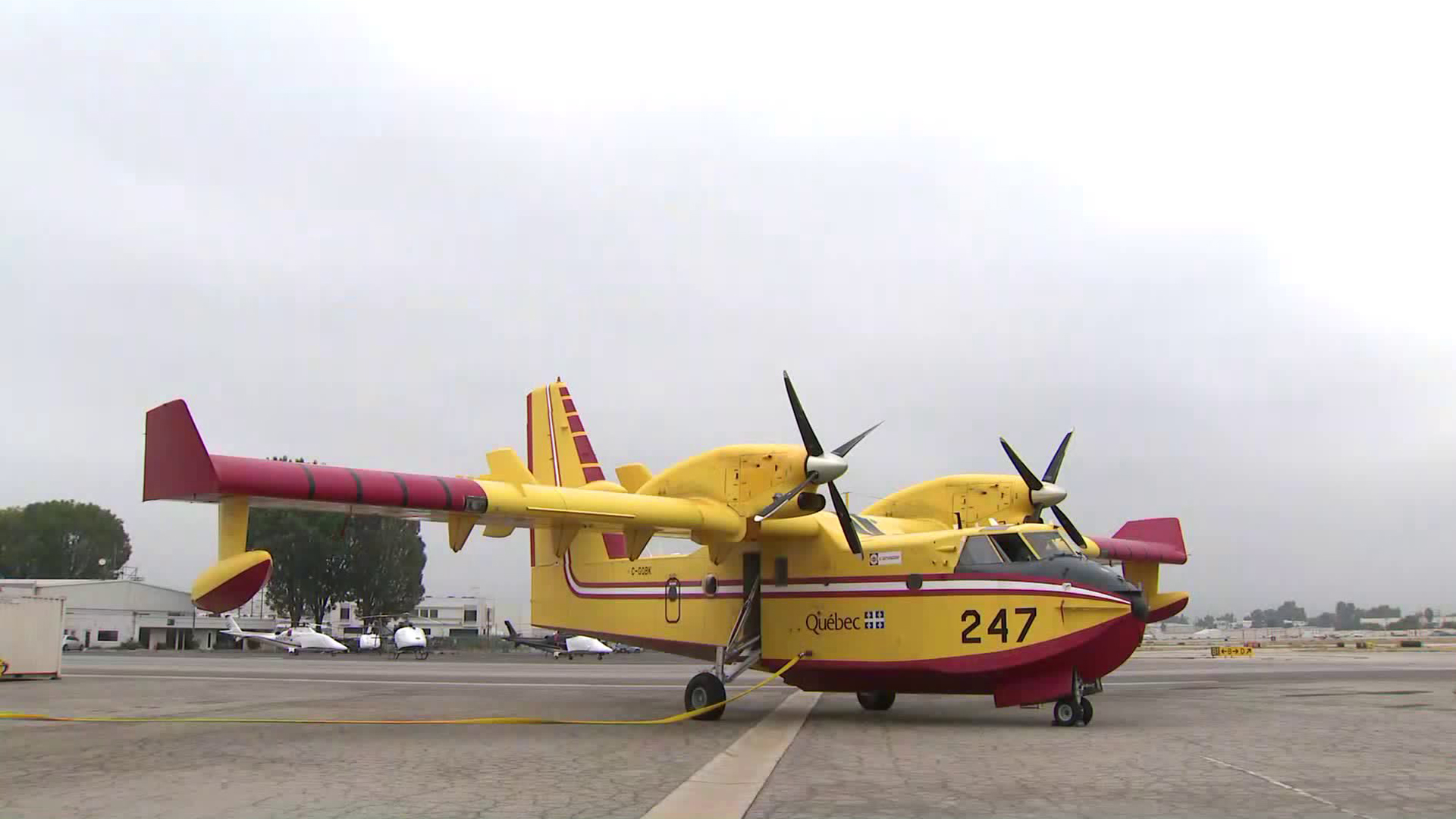 A CL-415 Super Scooper, one of two such aircraft leased from Quebec by Los Angeles County, is shown at a media event at Van Nuys Airport on Sept. 5, 2018, when it arrived for use in Southern California for the rest of the season. (Credit: KTLA)