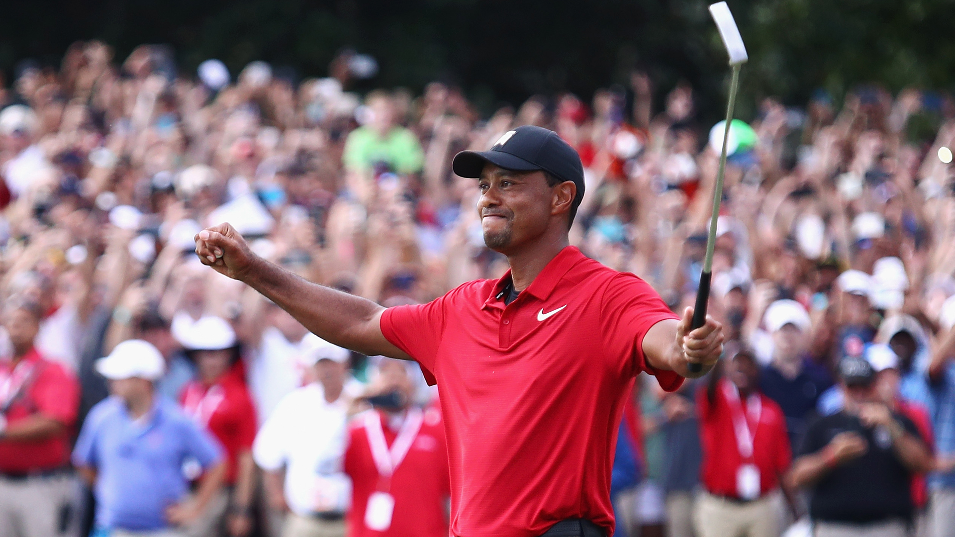 Tiger Woods celebrates making a par on the 18th green to win the TOUR Championship at East Lake Golf Club on September 23, 2018 in Atlanta, Georgia. (Photo by Tim Bradbury/Getty Images)