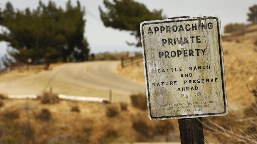 Signs warn of trespassing at Hollister Ranch Road. Mounting public outrage has fueled multiple new efforts by state officials to open a coveted stretch of California coastline. (Credit: Al Seib / Los Angeles Times)