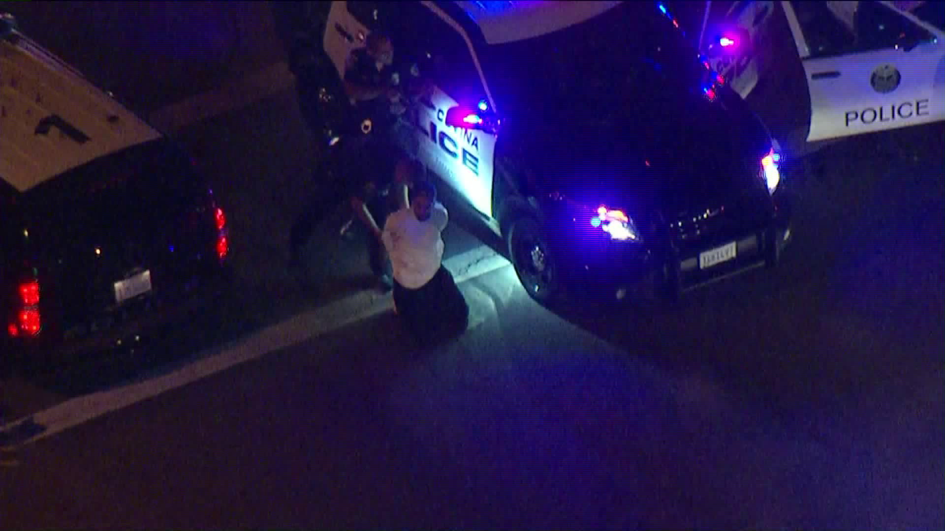 A driver who led authorities on a chase through the Corona area is seen kneeling as he's arrested on Oct. 30, 2018. (Credit: KTLA)