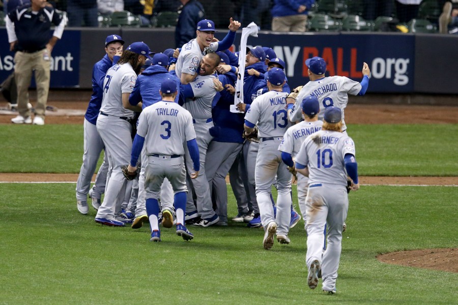 The Los Angeles Dodgers celebrate after defeating the Milwaukee Brewers in Game Seven to win the National League Championship Series at Miller Park on October 20, 2018 in Milwaukee, Wisconsin. (Credit: Dylan Buell/Getty Images)