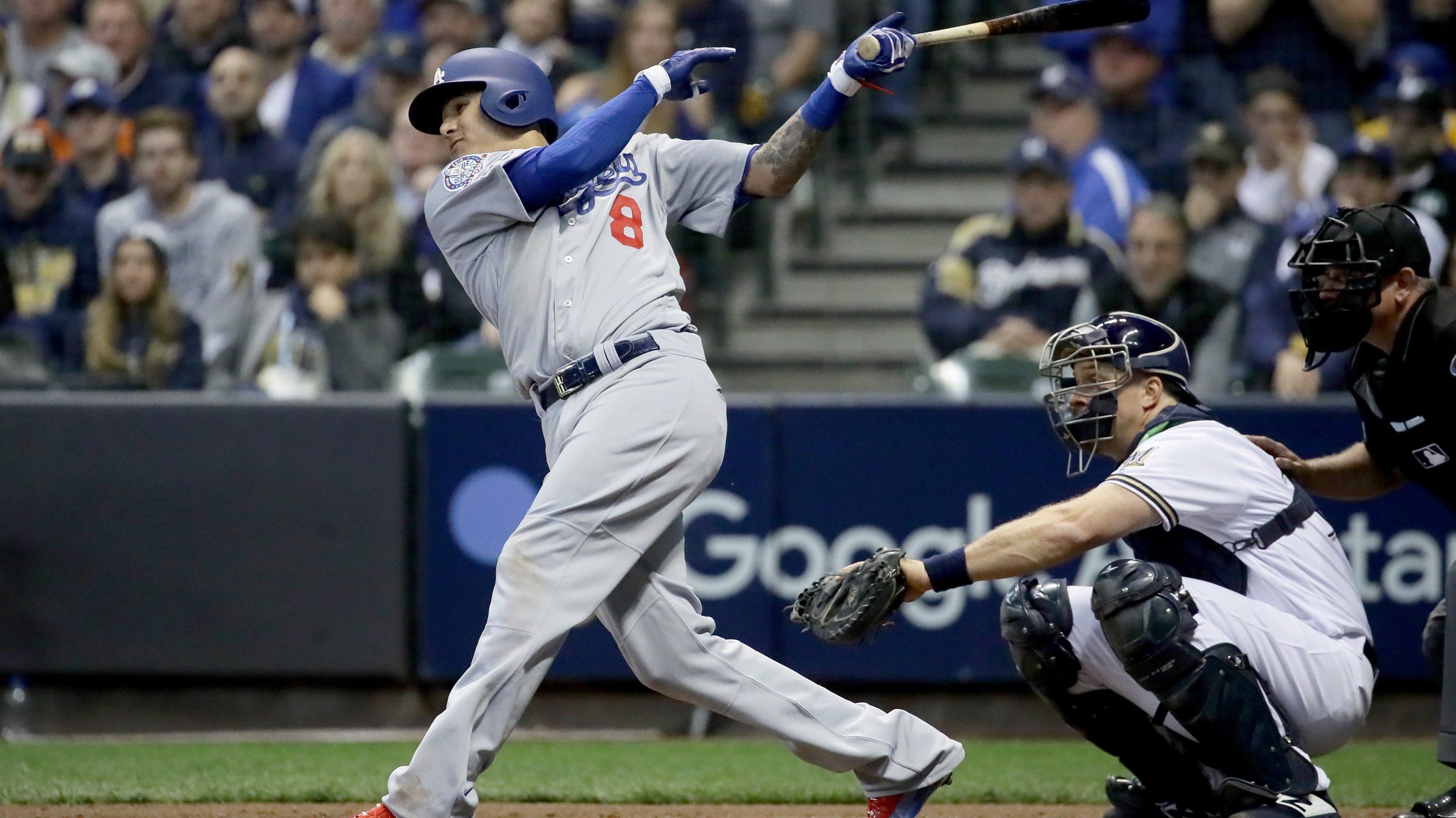 Manny Machado #8 of the Los Angeles Dodgers hits a single against the Milwaukee Brewers during the fourth inning Game Seven of the National League Championship Series at Miller Park on October 20, 2018 in Milwaukee, Wisconsin. (Credit: Jonathan Daniel/Getty Images)