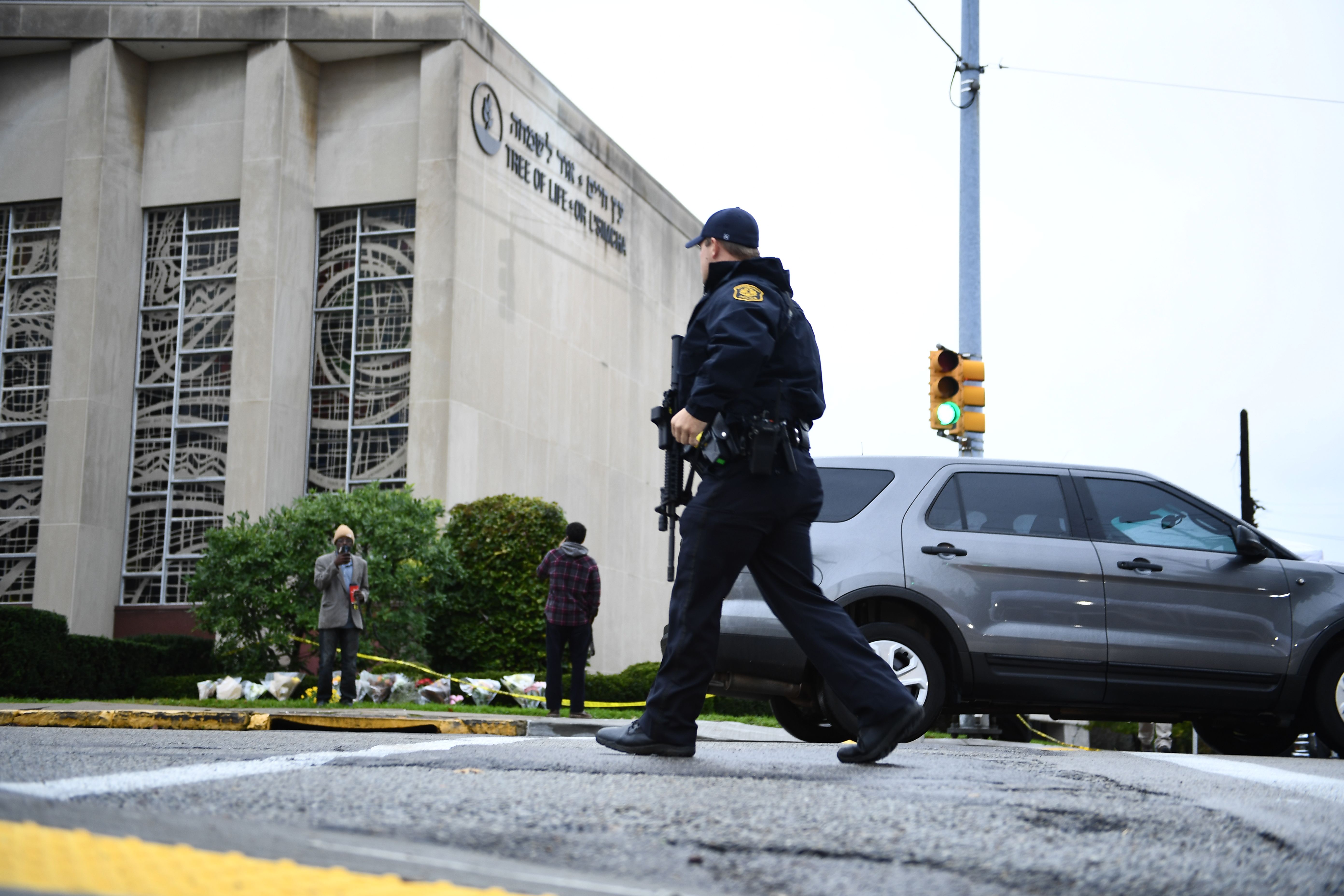 A member of the police crosses the street on October 28, 2018 outside the Tree of Life Synagogue after a shooting there left 11 people dead in the Squirrel Hill neighborhood of Pittsburgh on October 27, 2018. (Credit: Brendan Smialowski/AFP/Getty Images)