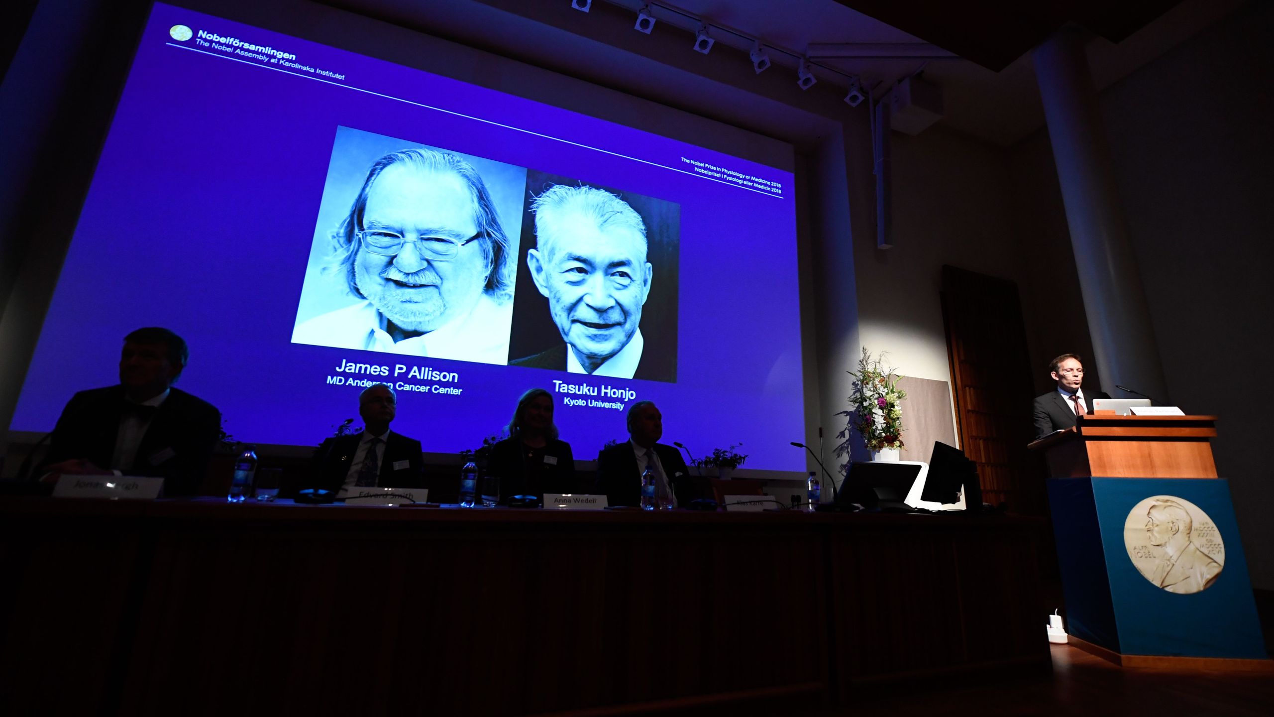 Secretary of the Nobel Committee for Physiology or Medicine, Thomas Perlmann (right) announces the winners of the 2018 Nobel Prize in Physiology or Medicine during a press conference at the Karolinska Institute in Stockholm, Sweden, on Oct. 1, 2018. (Credit: Jonathan Nackstrand/AFP/Getty Images)