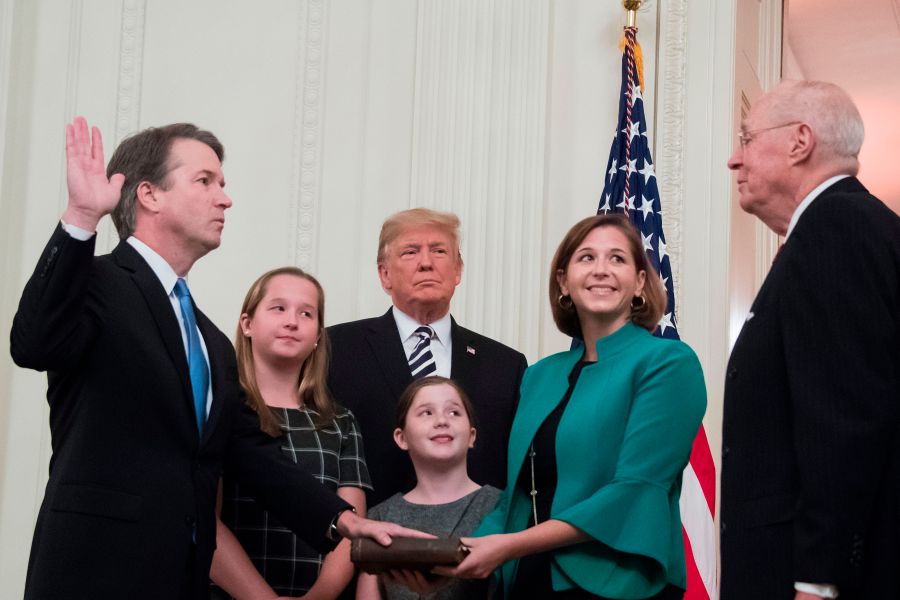 Brett Kavanaugh (L) is sworn-in as Associate Justice of the US Supreme Court by retired Associate Justice Anthony Kennedy on October 8, 2018, at the White House in Washington, DC. (Credit: JIM WATSON/AFP/Getty Images)