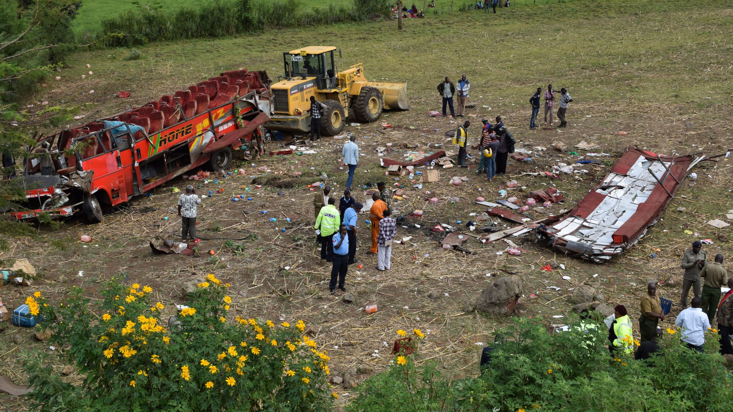 Kenyan emergency personnel and security forces inspect the wreckage of a bus at the site of an accident in Kericho, western Kenya, on October 10, 2018. (Credit: Brian Ongoro/AFP/Getty Images)