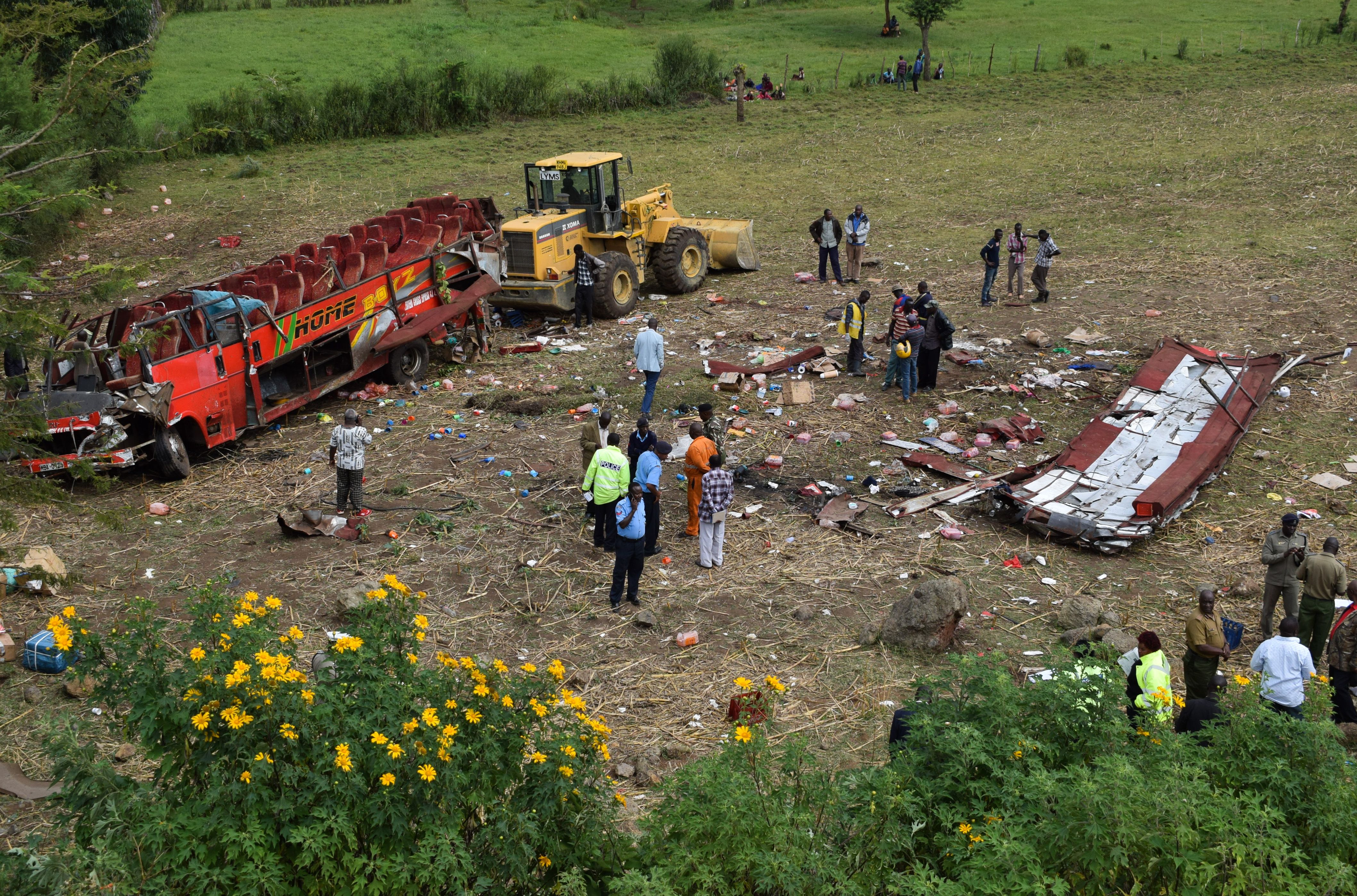 Kenyan emergency personnel and security forces inspect the wreckage of a bus at the site of an accident in Kericho, western Kenya, on October 10, 2018. (Credit: Brian Ongoro/AFP/Getty Images)