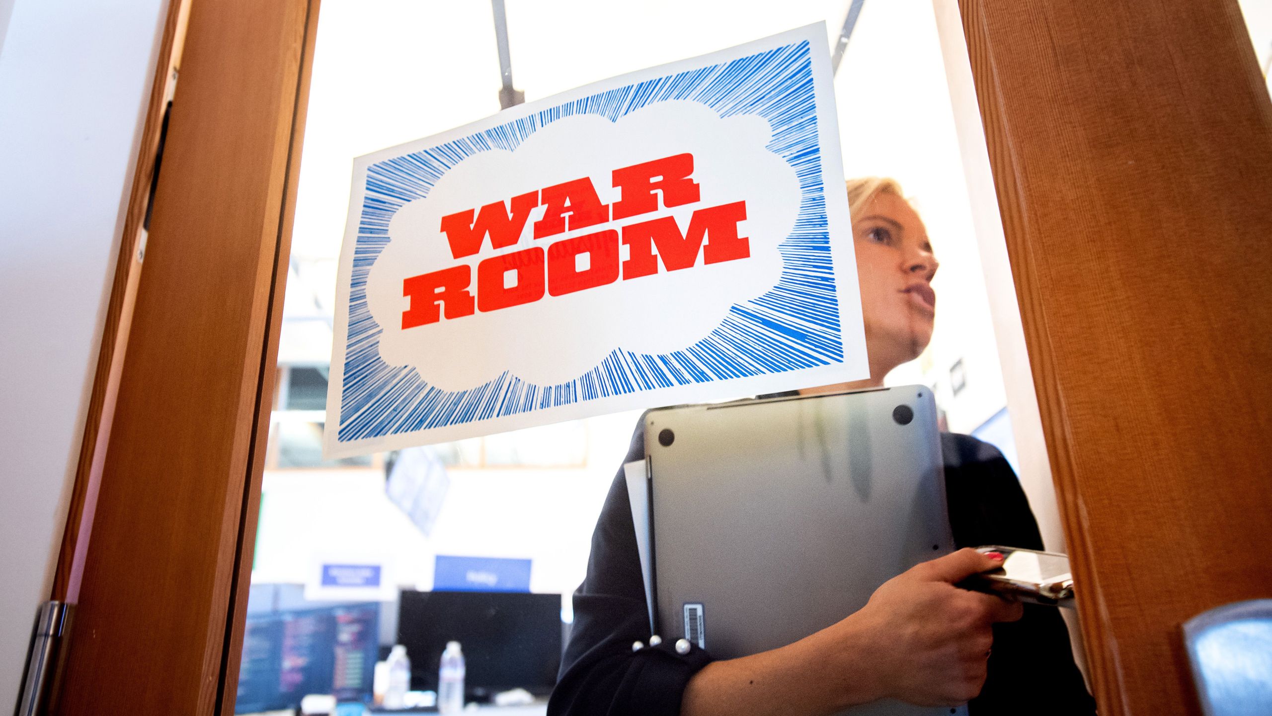 Facebook worker Erin Landers leaves the company's "War Room" during a media demonstration on Oct. 17, 2018 in Menlo Park. (Credit: NOAH BERGER/AFP/Getty Images)