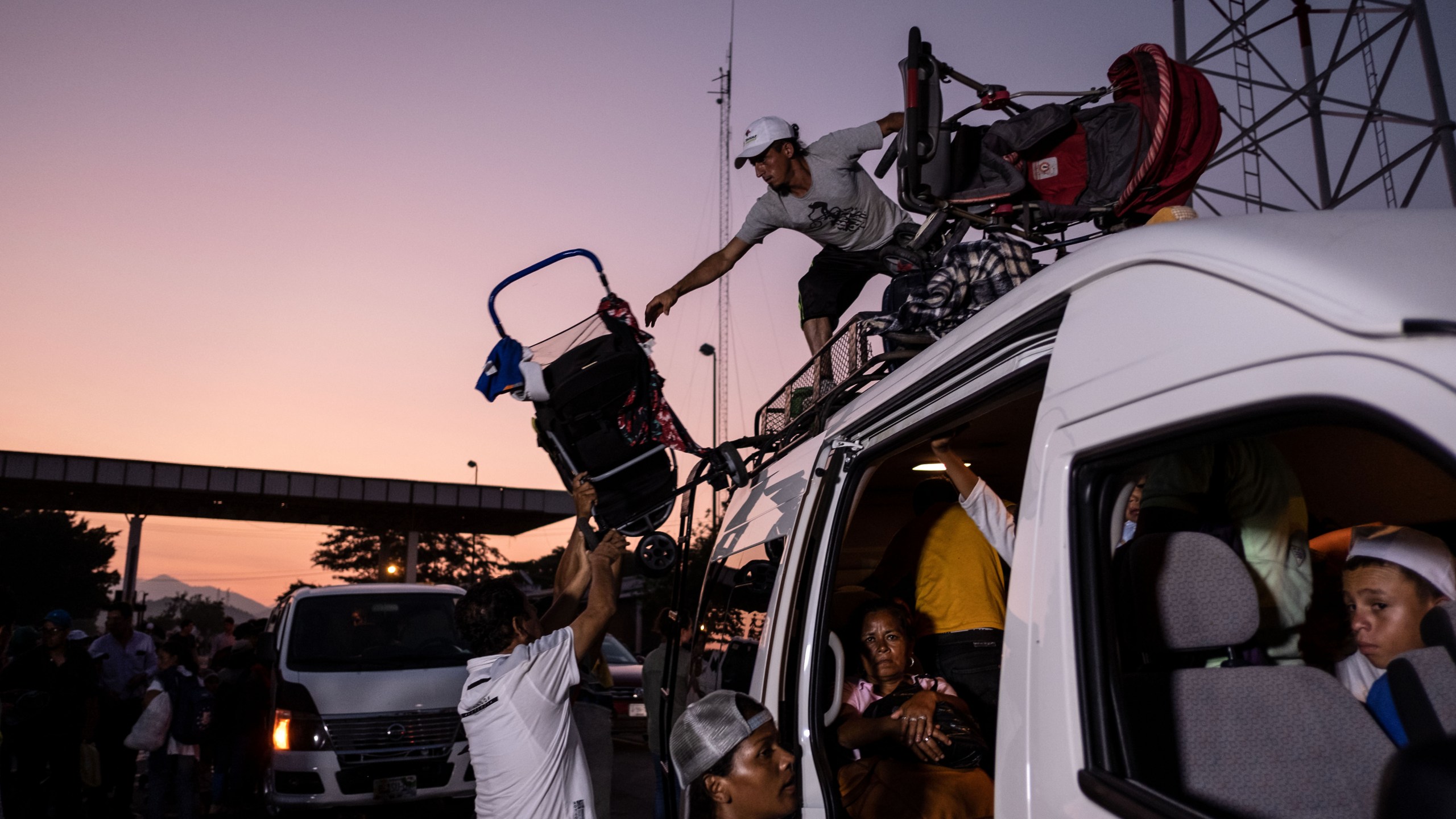 Honduran migrants heading in a caravan to the US, upload their baby strollers on a van, near Pijijiapan, southern Mexico on October 26, 2018. (Credit: Guillermo Arias/AFP/Getty Images)