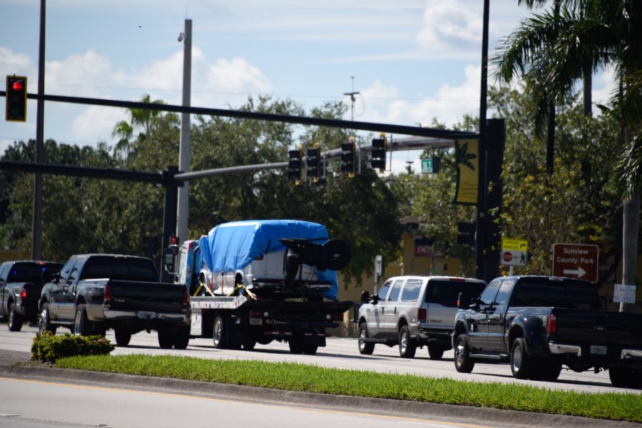 A van covered in blue tarp is towed by FBI investigators on October 26, 2018, in Plantation, Florida, in connection with the 12 pipe bombs and suspicious packages mailed to top Democrats. (Credit: MICHELE EVE SANDBERG/AFP/Getty Images)