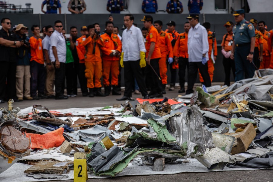 Indonesia's President Joko Widodo (center), inspects recovered debris and personal items from Lion Air flight JT 610 at the Tanjung Priok port on Oct. 30, 2018. (Credit: Ulet Ifansasti/Getty Images)