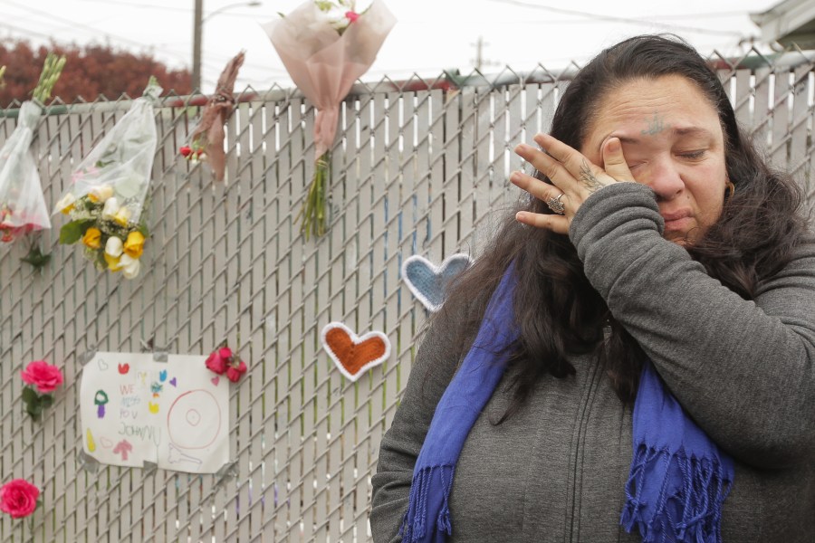 Danielle Boudreaux, who knew the man who rented out the Ghost Ship warehouse for parties and was a frequent visitor herself, cries by a makeshift memorial near the site of a warehouse fire that has claimed the lives of at least 36 people on Dec. 5, 2016, in Oakland. (Credit: Elijah Nouvelage/Getty Images)