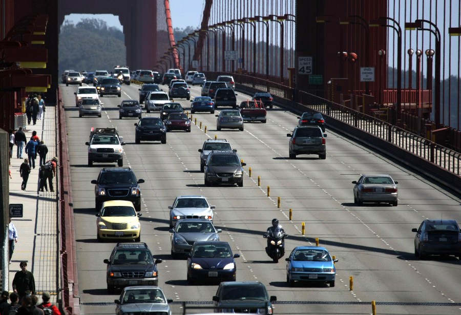 Cars drive across the Golden Gate Bridge May 19, 2009, in San Francisco. At the time, President Obama had announced a new national fuel and emission standards program for cars and trucks with the intention of cutting vehicle carbon emissions and raising mileage by 30 percent. (Credit: Justin Sullivan/Getty Images)