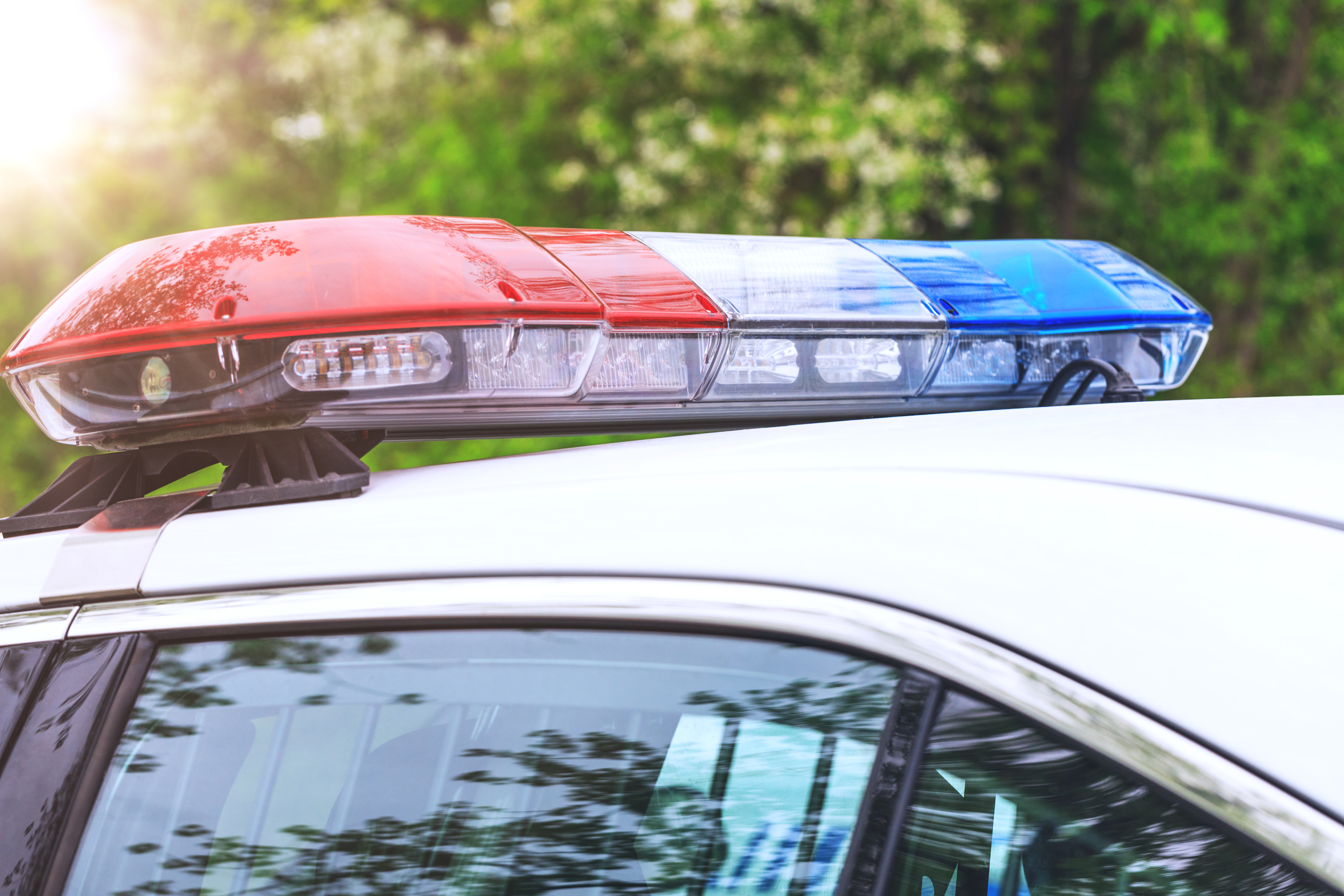 A police patrol car is seen with sirens off. (Credit: iStock / Getty Images Plus)