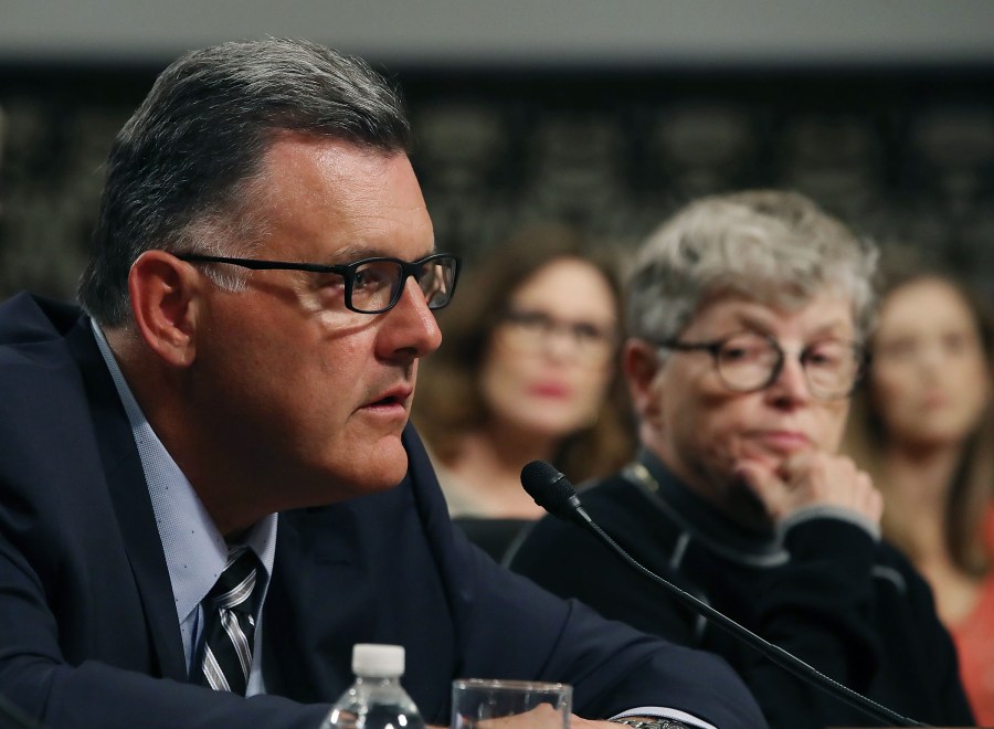 Steve Penny, former president of USA Gymnastics, pleads the Fifth, while seated next to Lou Anna Simon, right, former president of Michigan State University, during a Senate committee hearing on June 5, 2018. (Credit: Mark Wilson / Getty Images)