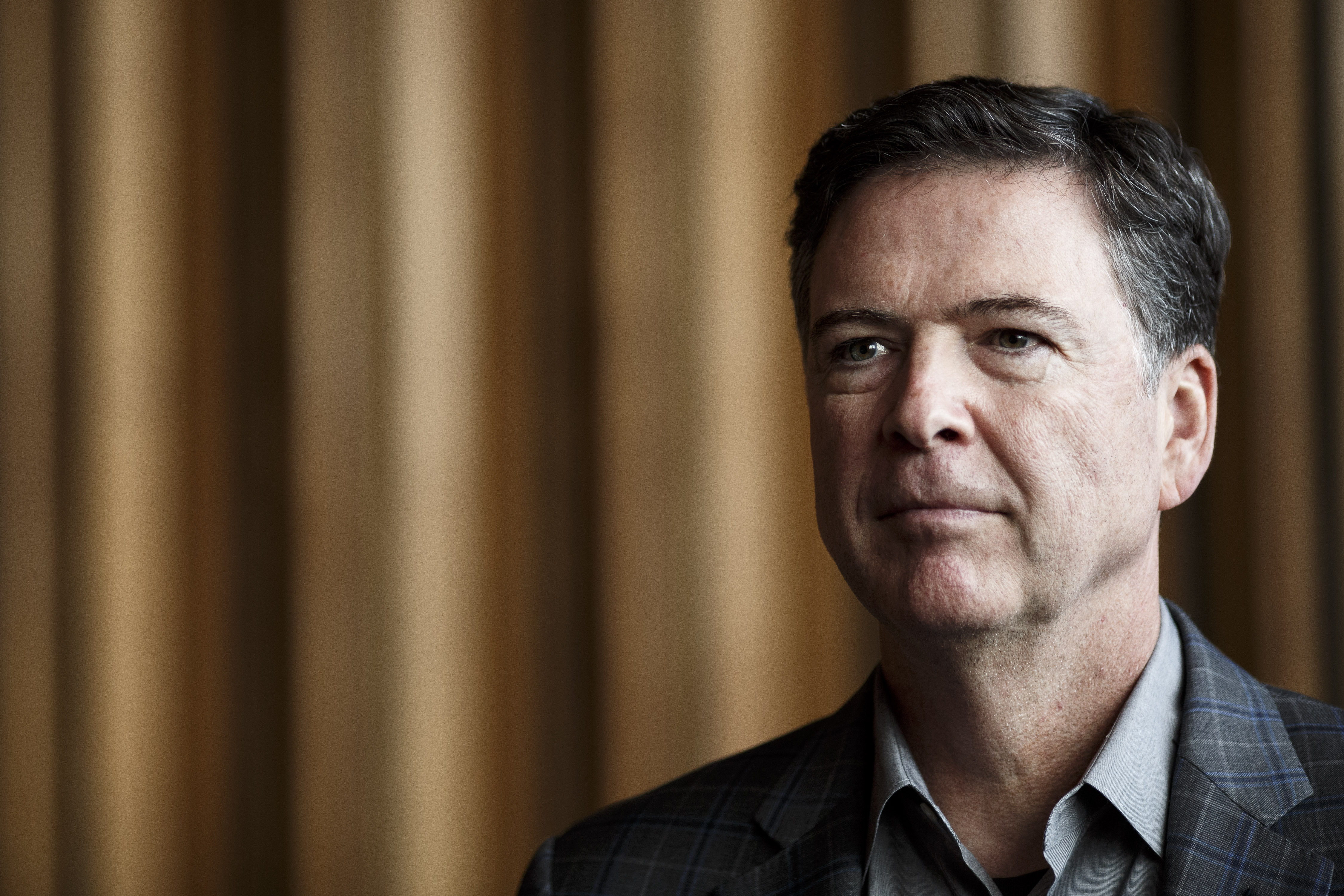 Former FBI Director James Comey talks backstage before a panel discussion about his book on June 19, 2018 in Berlin, Germany. (Credit: Carsten Koall/Getty Images)