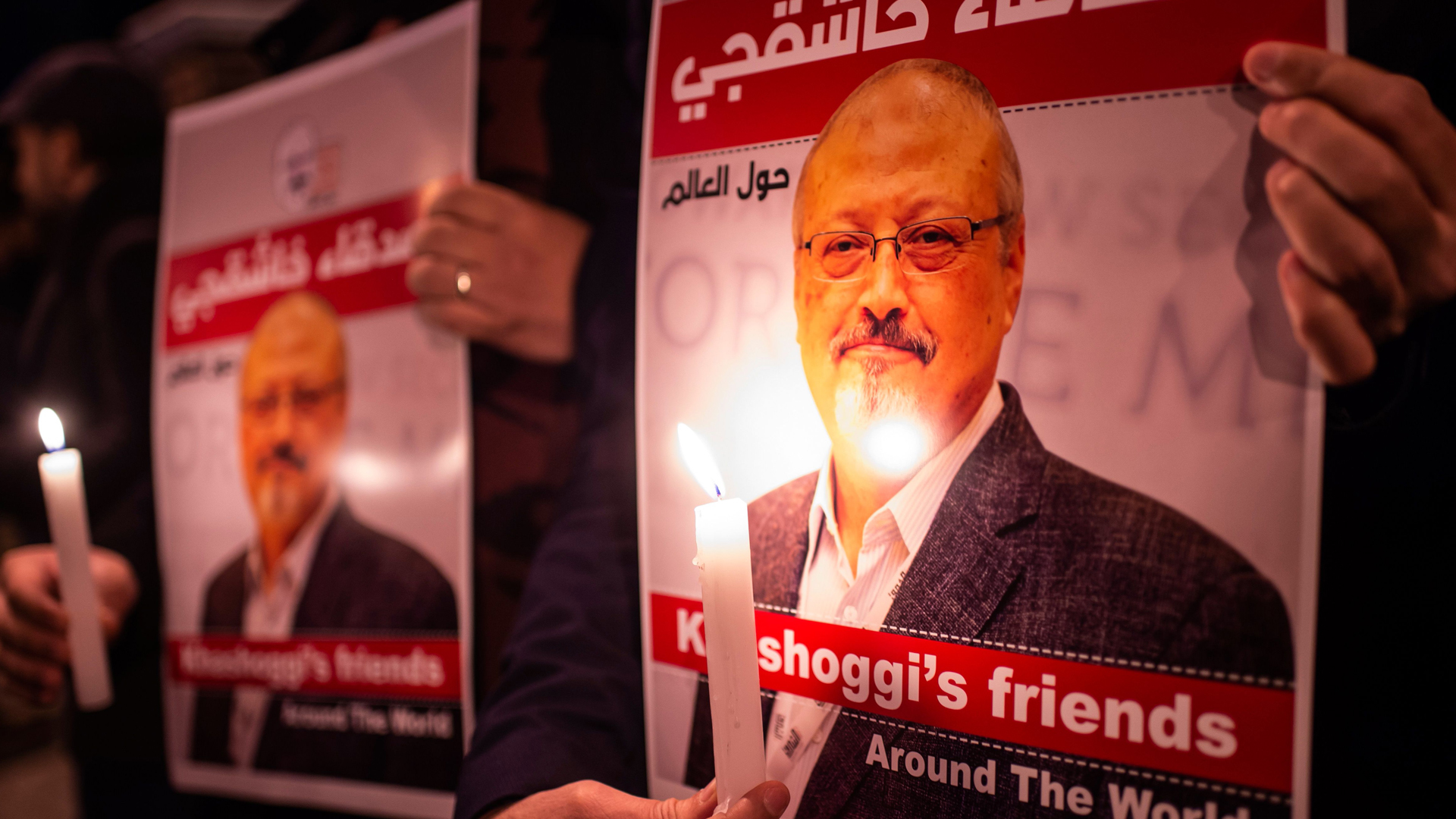 People hold posters picturing Saudi journalist Jamal Khashoggi and lightened candles during a gathering outside the Saudi Arabia consulate in Istanbul, on Oct. 25, 2018. (Credit: YASIN AKGUL/AFP/Getty Images)