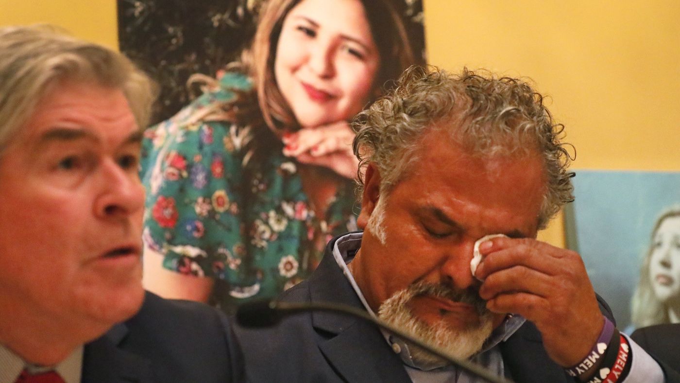 Salvador Albert Corado, father of Melyda Corado, who was shot and killed by LAPD officers at a Trader Joe's in Silver Lake, during a press conference with a family attorney, John Taylor. Melyda's photo is in the background. (Credit: Al Seib / Los Angeles Times)