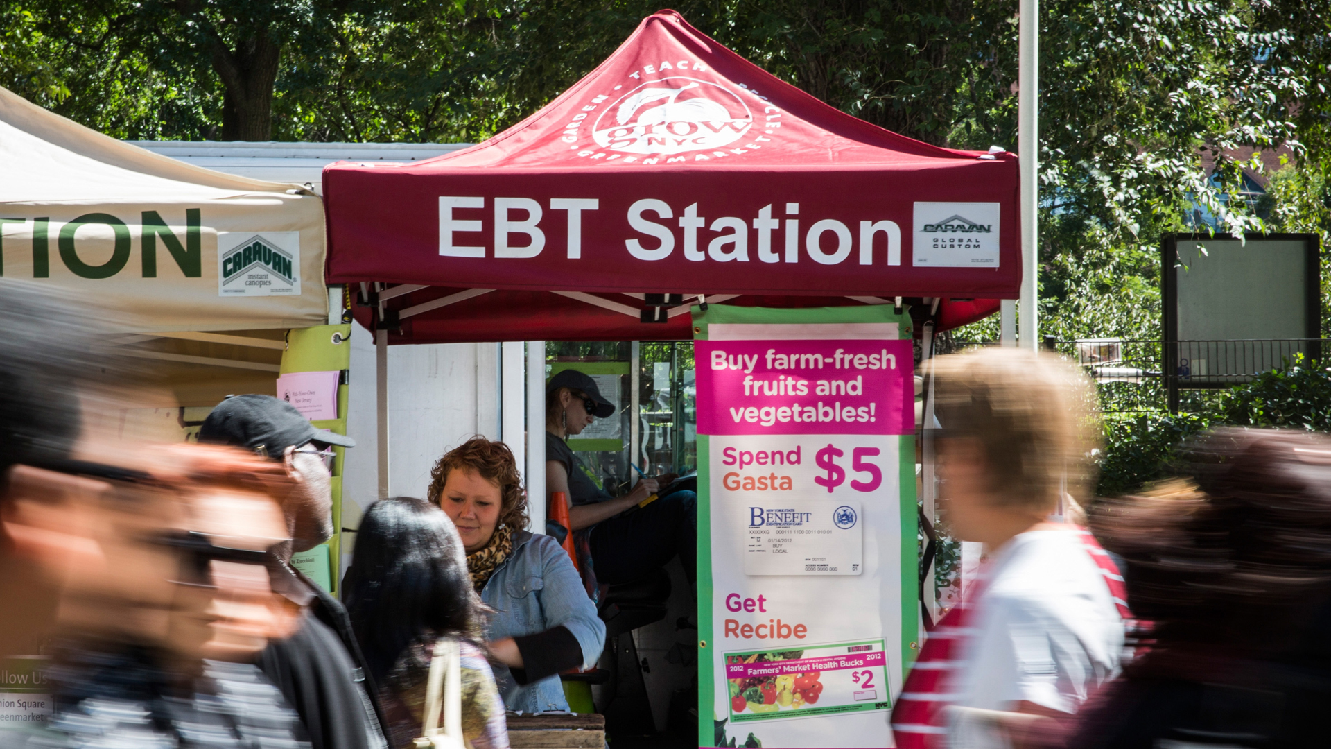 People walk past an Electronic Benefits Transfer (EBT) station, more commonly known as Food Stamps, in the GrowNYC Greenmarket in Union Square on Sept. 18, 2013, in New York City. (Credit: Andrew Burton/Getty Images)