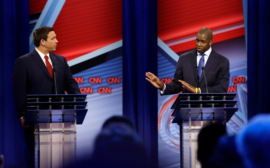 Florida Democratic gubernatorial candidate Andrew Gillum, right, addresses his Florida Republican opponent Ron DeSantis during a CNN debate on Oct. 21, 2018, in Tampa, Florida. (Credit: Chris O'Meara-Pool/Getty Images)