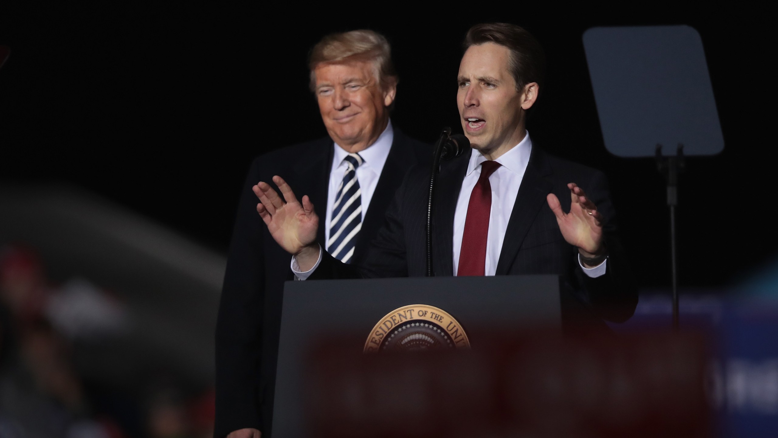 Donald Trump listens as Josh Hawley speaks at a rally on Nov. 1, 2018 in Columbia, Missouri. (Credit: Scott Olson/Getty Images)