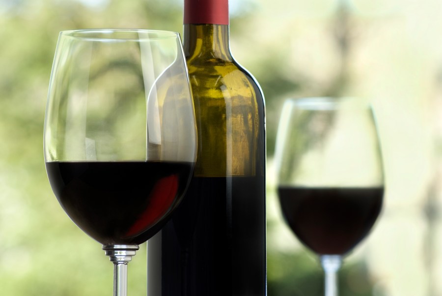 A file photo shows a bottle and two glasses of wine. (Credit: Getty Images)