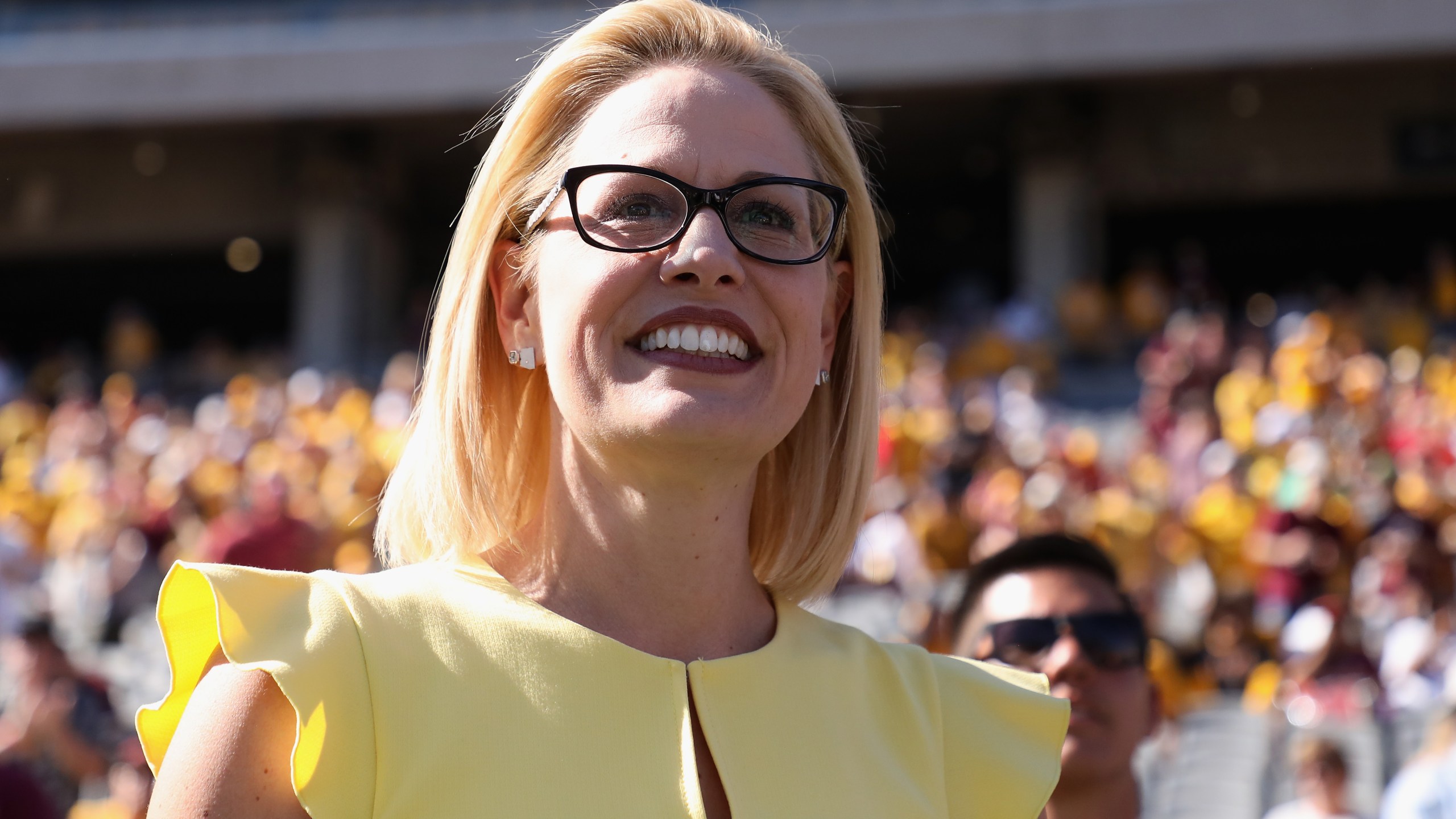 Democratic U.S. Senate candidate Rep. Kyrsten Sinema participates in the pregame coin toss before the game between the Utah Utes and the Arizona State Sun Devils at Sun Devil Stadium on Nov. 3, 2018, in Tempe, Arizona. (Credit: Christian Petersen/Getty Images)