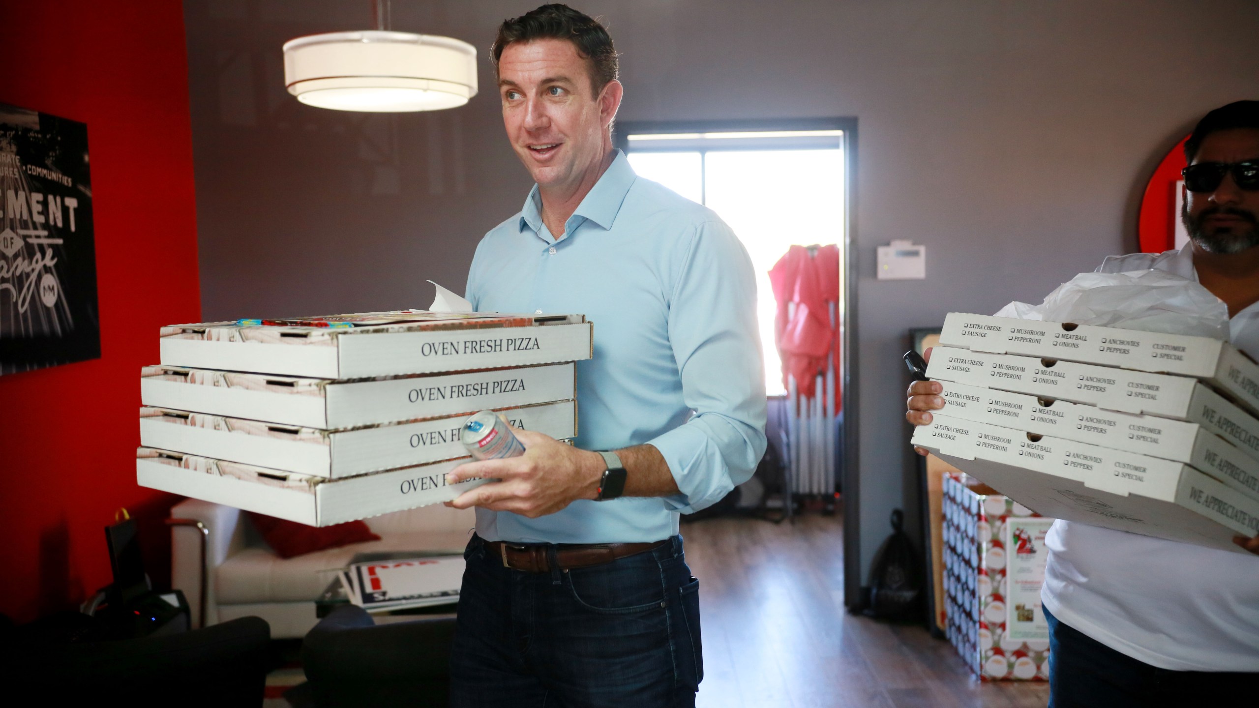 Rep. Duncan Hunter (R-CA) brings pizza to campaign staffers during a visit to one of his headquarters on Nov. 6, 2018, in Santee. (Credit: Sandy Huffaker/Getty Images)