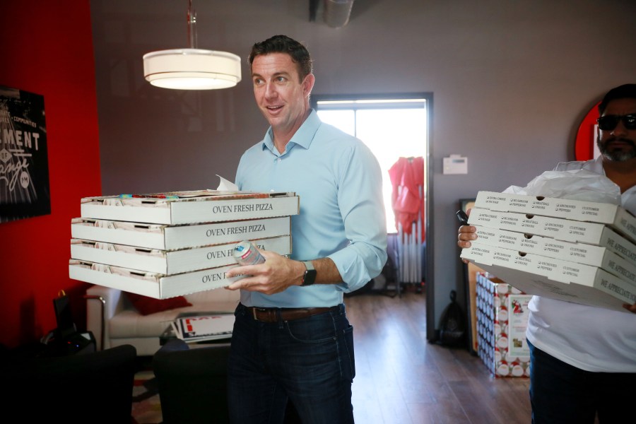 Rep. Duncan Hunter (R-CA) brings pizza to campaign staffers during a visit to one of his headquarters on Nov. 6, 2018, in Santee. (Credit: Sandy Huffaker/Getty Images)