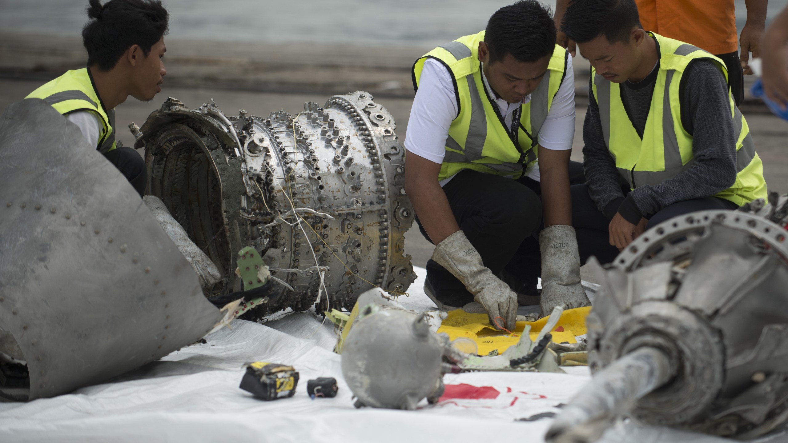 Investigators examine engine parts from the ill-fated Lion Air flight JT 610 at a port in Jakarta on Nov. 7, 2018, after they were recovered from the bottom of the Java sea. (Credit: Bay Ismoyo / AFP / Getty Images)