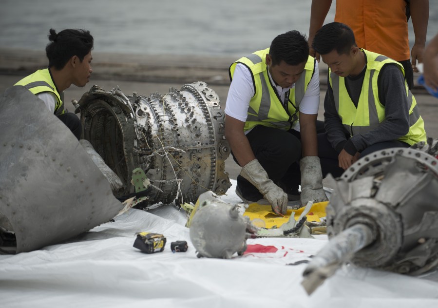 Investigators examine engine parts from the ill-fated Lion Air flight JT 610 at a port in Jakarta on Nov. 7, 2018, after they were recovered from the bottom of the Java sea. (Credit: Bay Ismoyo / AFP / Getty Images)