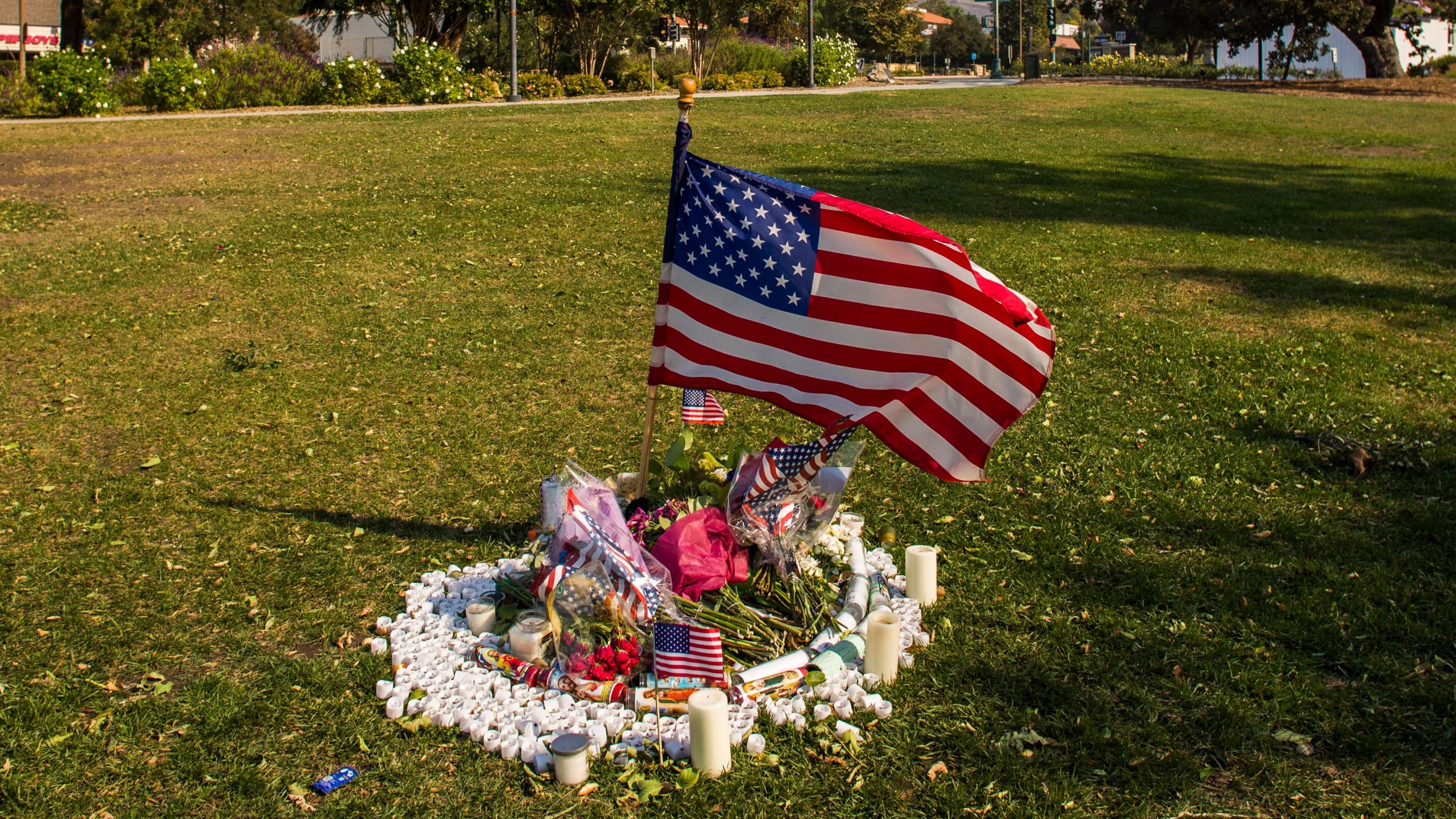 Flowers and candles are left in front of Thousands Oaks City Hall in tribute to the victims of the Borderline Bar & Grill mass shooting in Thousands on November 09, 2018. (Credit: APU GOMES/AFP/Getty Images)