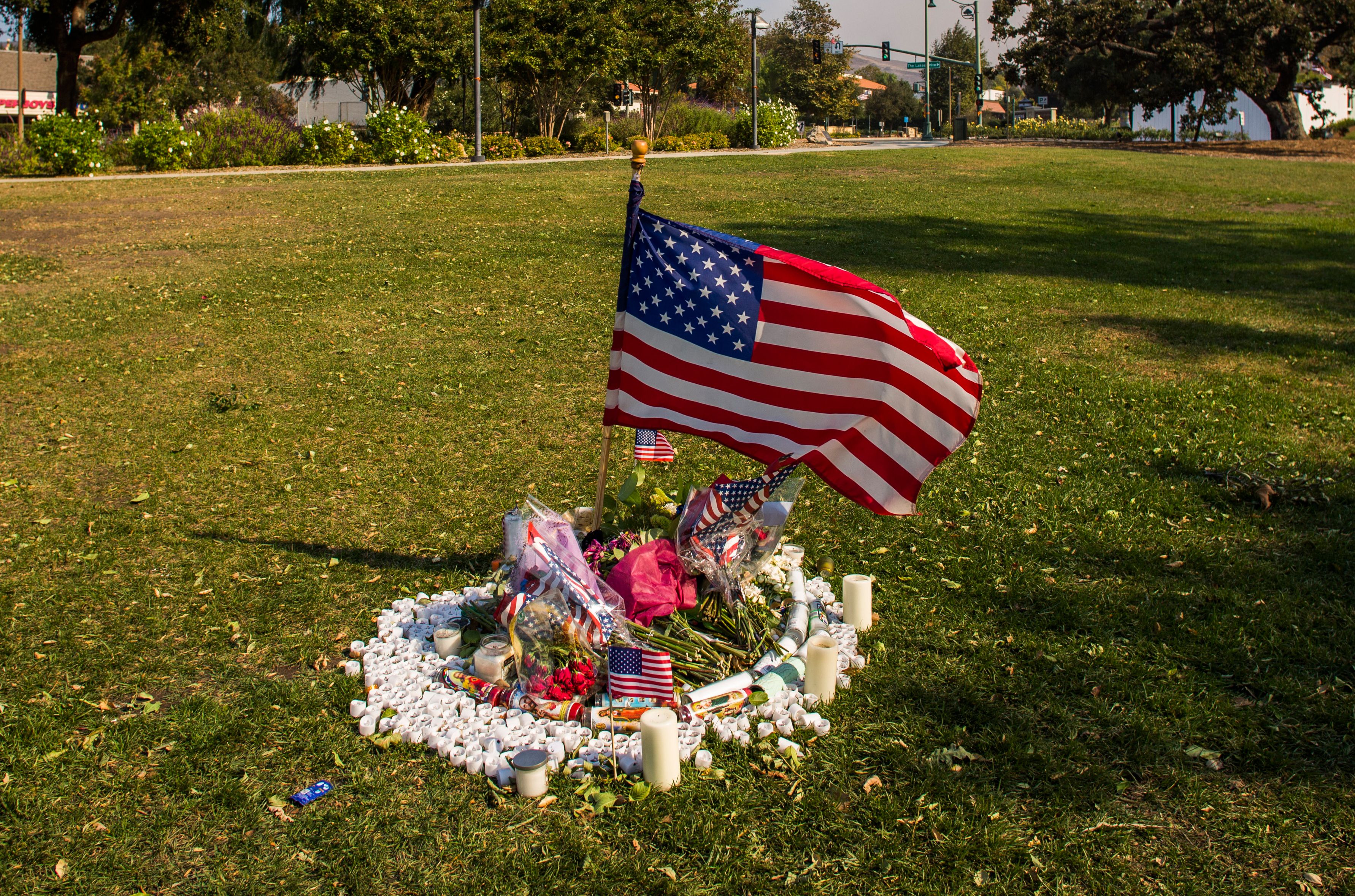 Flowers and candles are left in front of Thousands Oaks City Hall in tribute to the victims of the Borderline Bar & Grill mass shooting in Thousands on November 09, 2018. (Credit: APU GOMES/AFP/Getty Images)