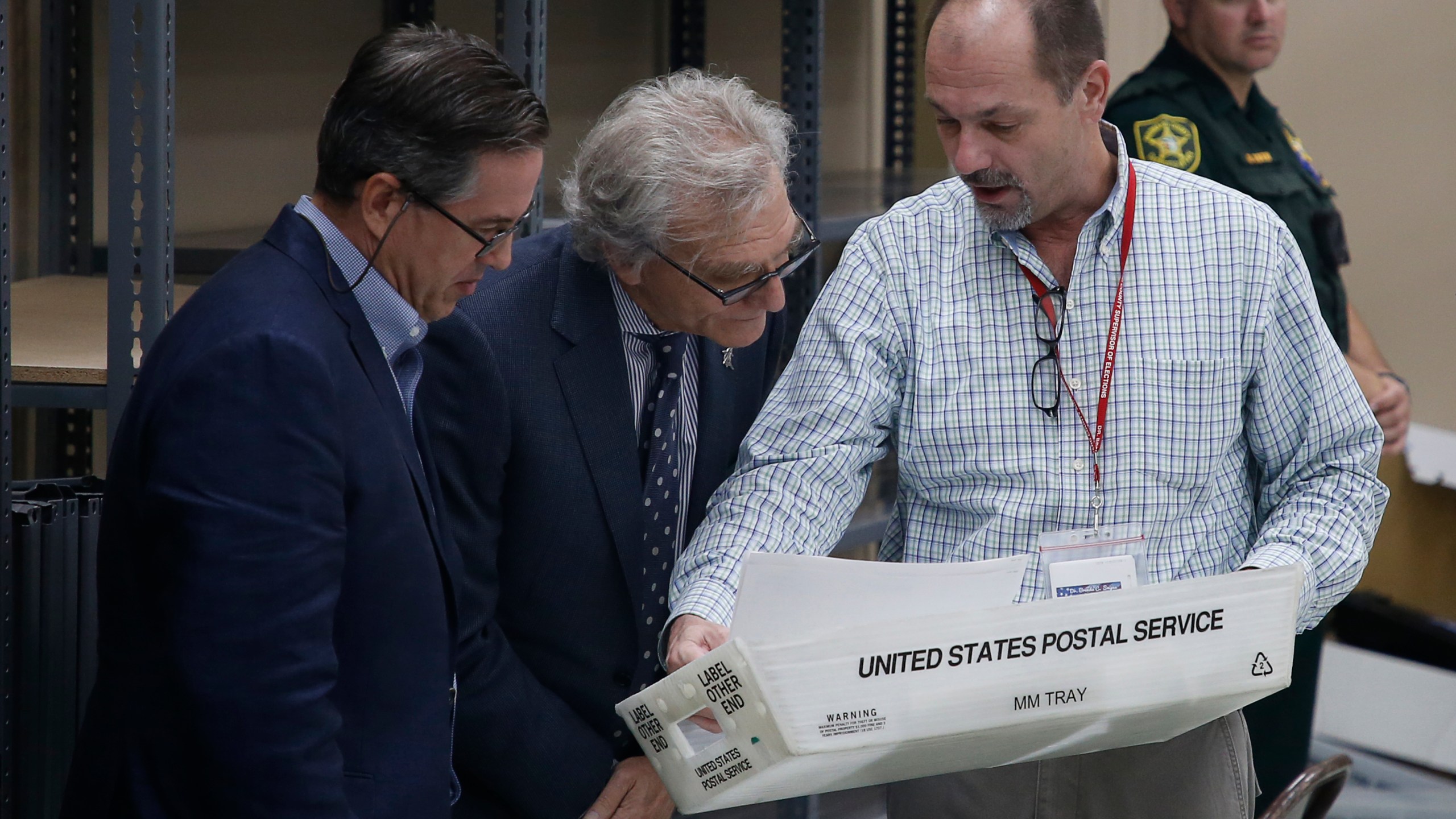 An elections official, right, shows party observers results of voting machine calibrations prior to the start of a recount of all votes at the Broward County Supervisor of Elections Office on Nov. 11, 2018 in Lauderhill, Florida. (Credit: Joe Skipper/Getty Images)