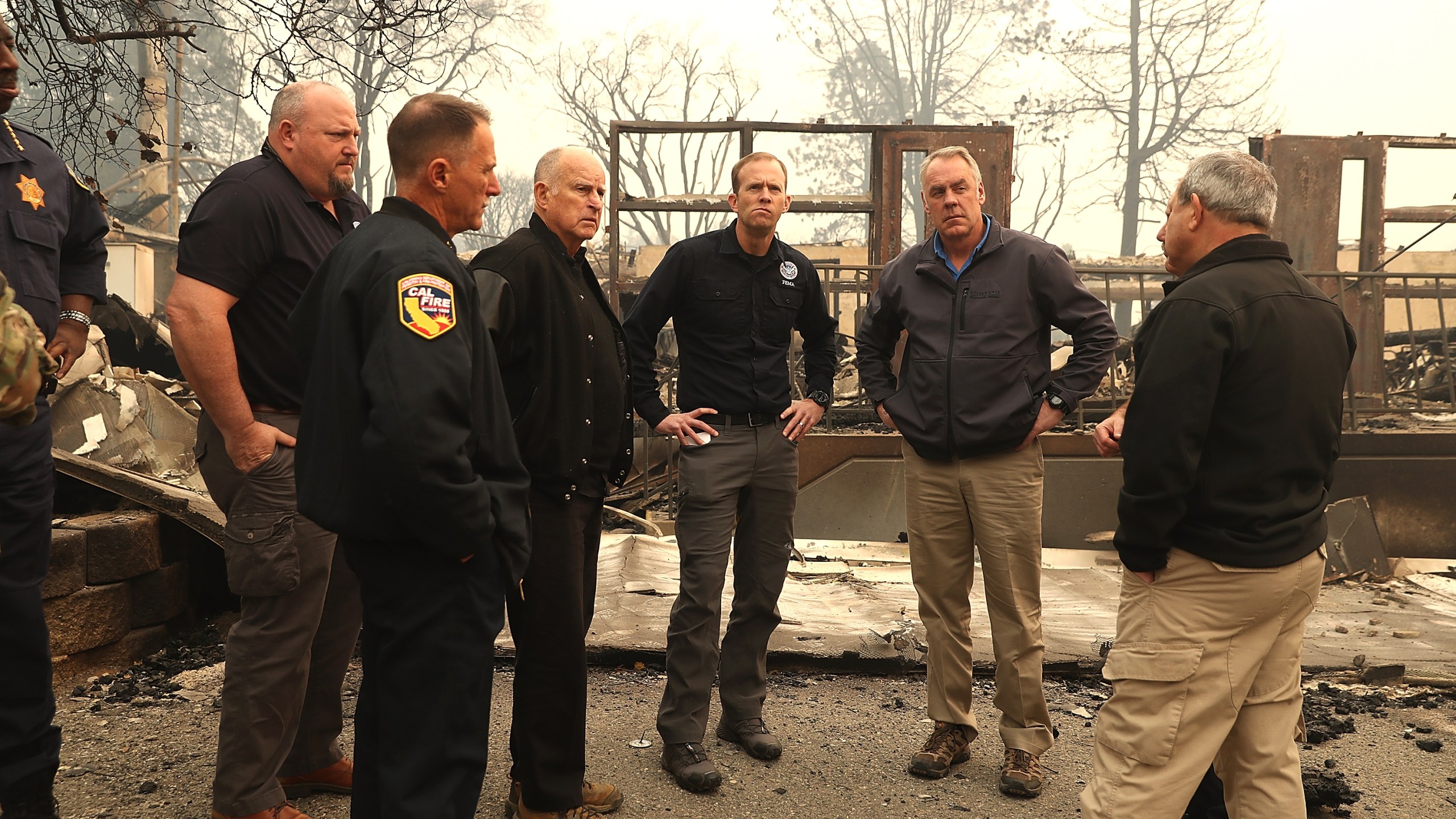 Gov. Jerry Brown and FEMA Adminstrator Brock Long and Secretary of the Interior Ryan Zinke tour a school burned by the Camp Fire on November 14, 2018 in Paradise. (Credit: Justin Sullivan/Getty Images)