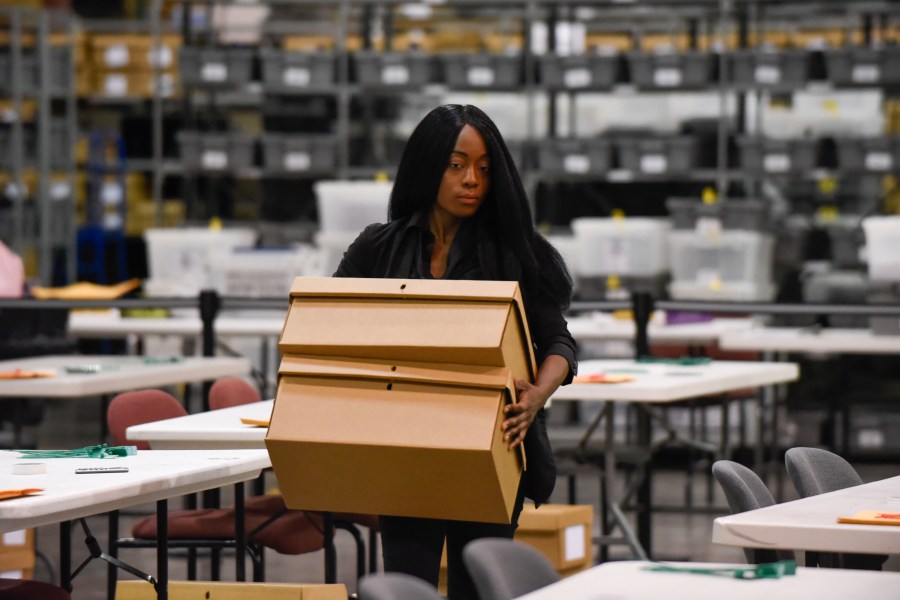 A woman sets up tables for hand counting ballots on November 15, 2018, as Palm Beach County did not meet the midterm recount deadline in West Palm Beach, Florida. (Credit: MICHELE EVE SANDBERG/AFP/Getty Images)