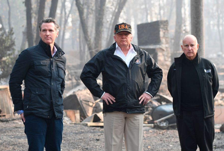 Donald Trump stands alongside Gov. Jerry Brown and Gov.-elect Gavin Newsom as they view damage from the Camp Fire in Paradise, California on Nov. 17, 2018. (SAUL LOEB/AFP/Getty Images)