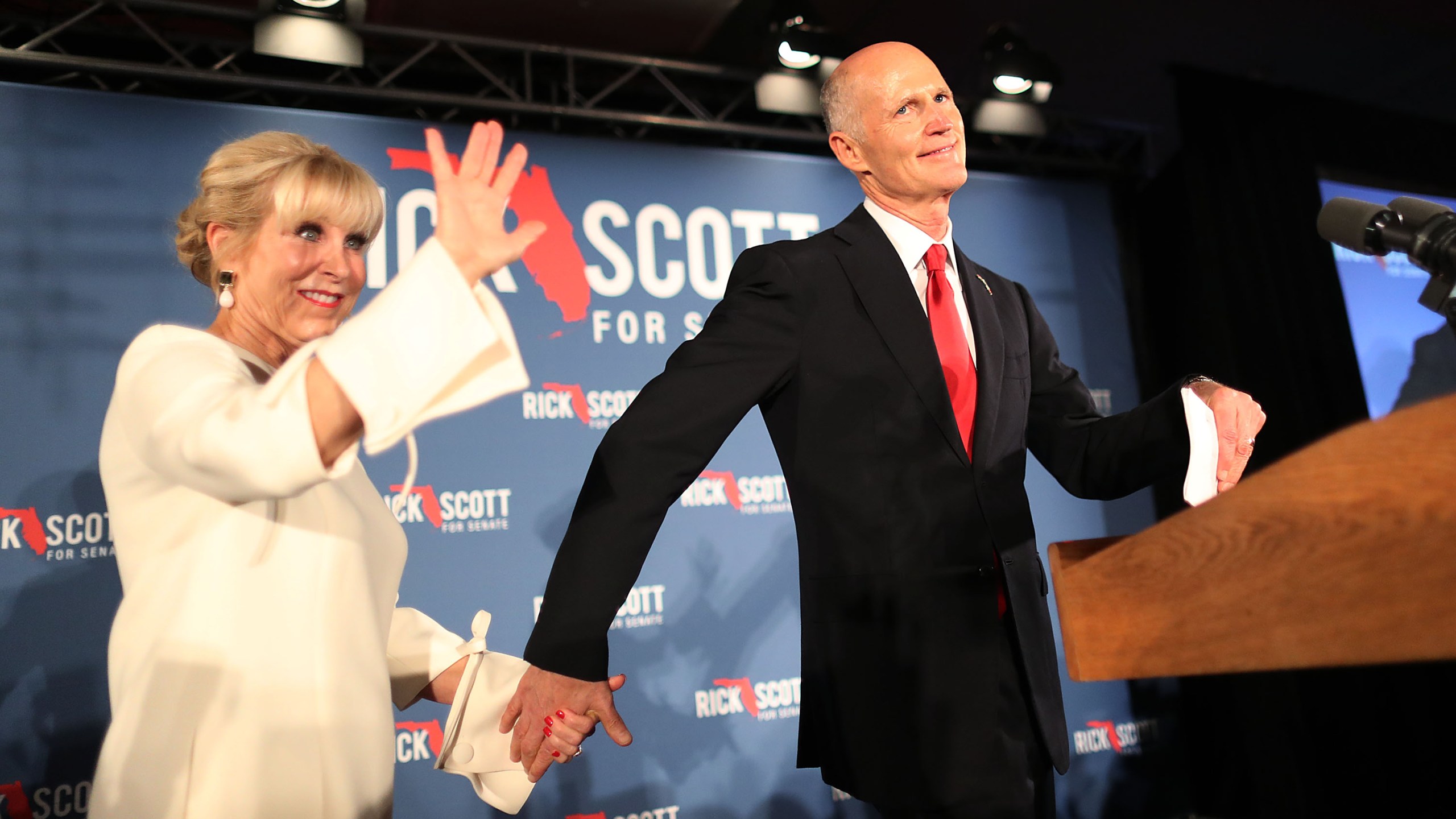 Florida Gov. Rick Scott and his wife, Ann Scott, take to the stage during his election night party at the LaPlaya Beach & Golf Resort on Nov. 06, 2018, in Naples, Fla. (Credit: Joe Raedle/Getty Images)