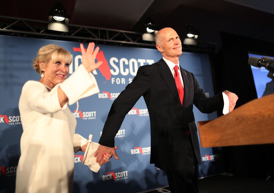 Florida Gov. Rick Scott and his wife, Ann Scott, take to the stage during his election night party at the LaPlaya Beach & Golf Resort on Nov. 06, 2018, in Naples, Fla. (Credit: Joe Raedle/Getty Images)