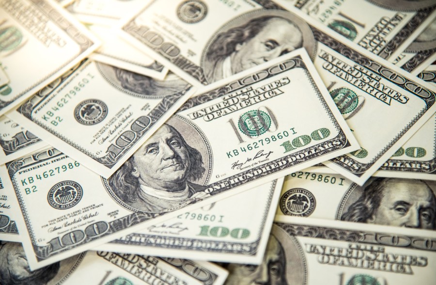 A pile of $100 bills is seen in a file photo. (Credit: iStock / Getty Images Plus)