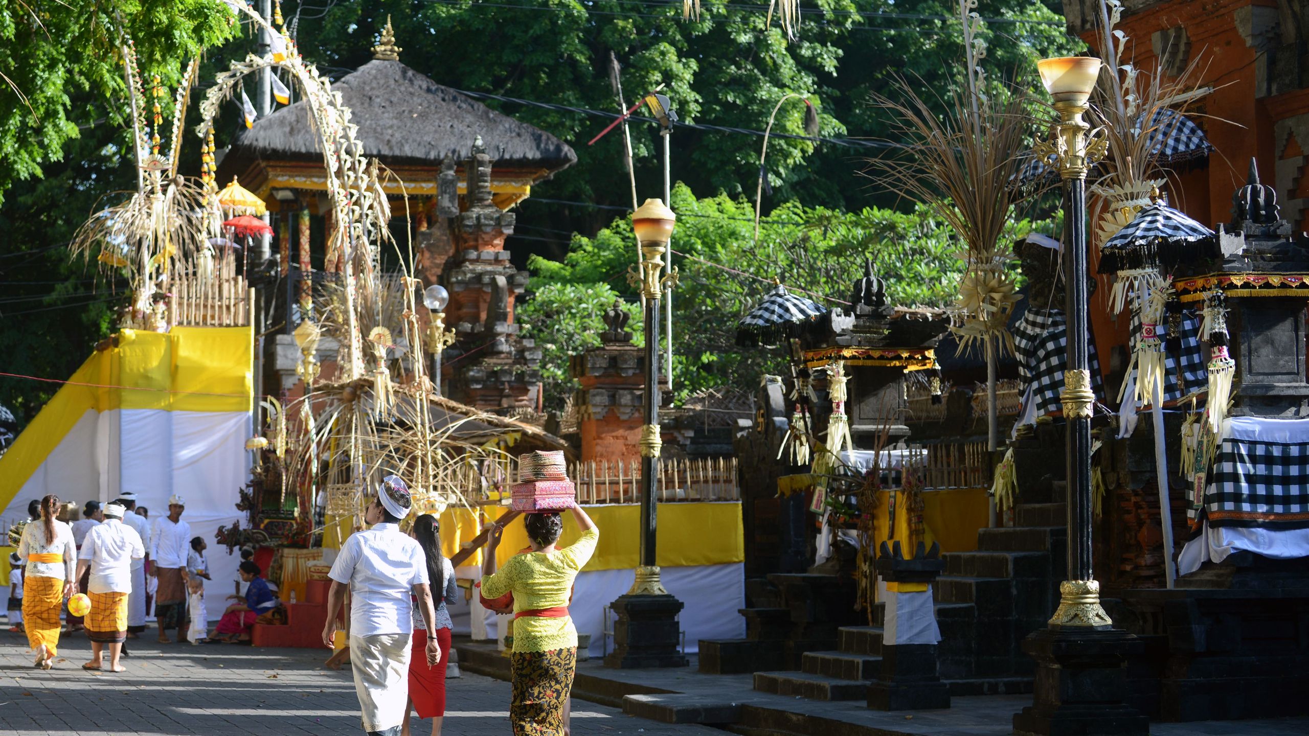 Balinese Hindus arrive for prayers to celebrate the religous festival Galungan at the Jagat Natha temple in Denpasar on Indonesia's Bali island on Nov. 1, 2017. (Credit: SONNY TUMBELAKA/AFP/Getty Images)