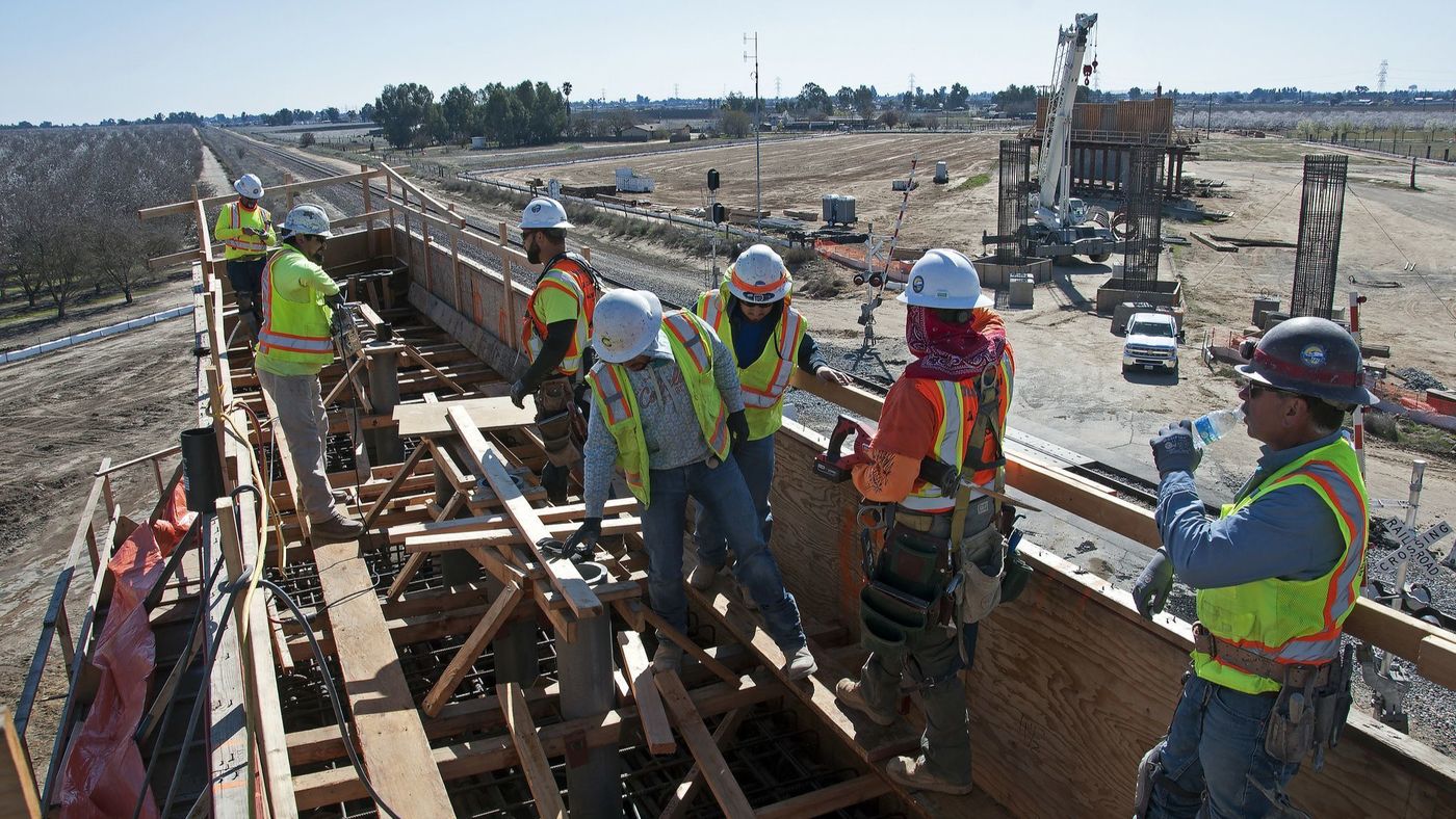 Crews are seen working on a bullet train overpass in Madera County in February in a photo released by the California High-Speed Rail Authority.