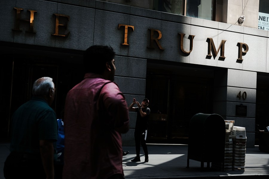 People walk outside of a building owned by President Donald Trump in Manhattan on August 24, 2018 in New York City. (Credit: Spencer Platt/Getty Images)