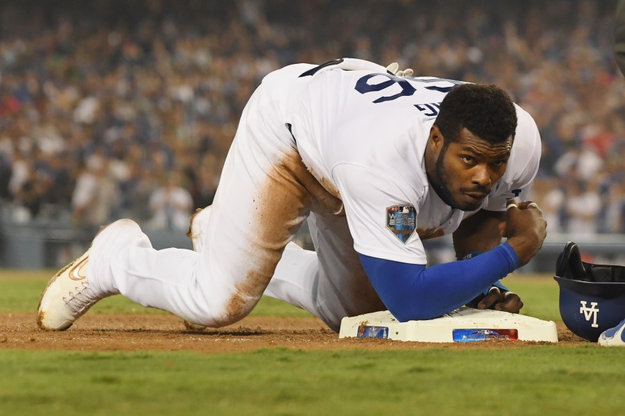 Yasiel Puig of the Los Angeles Dodgers slides safely into third base during Game Four of the 2018 World Series against the Boston Red Sox at Dodger Stadium on Oct. 27, 2018. (Credit: Harry How / Getty Images)