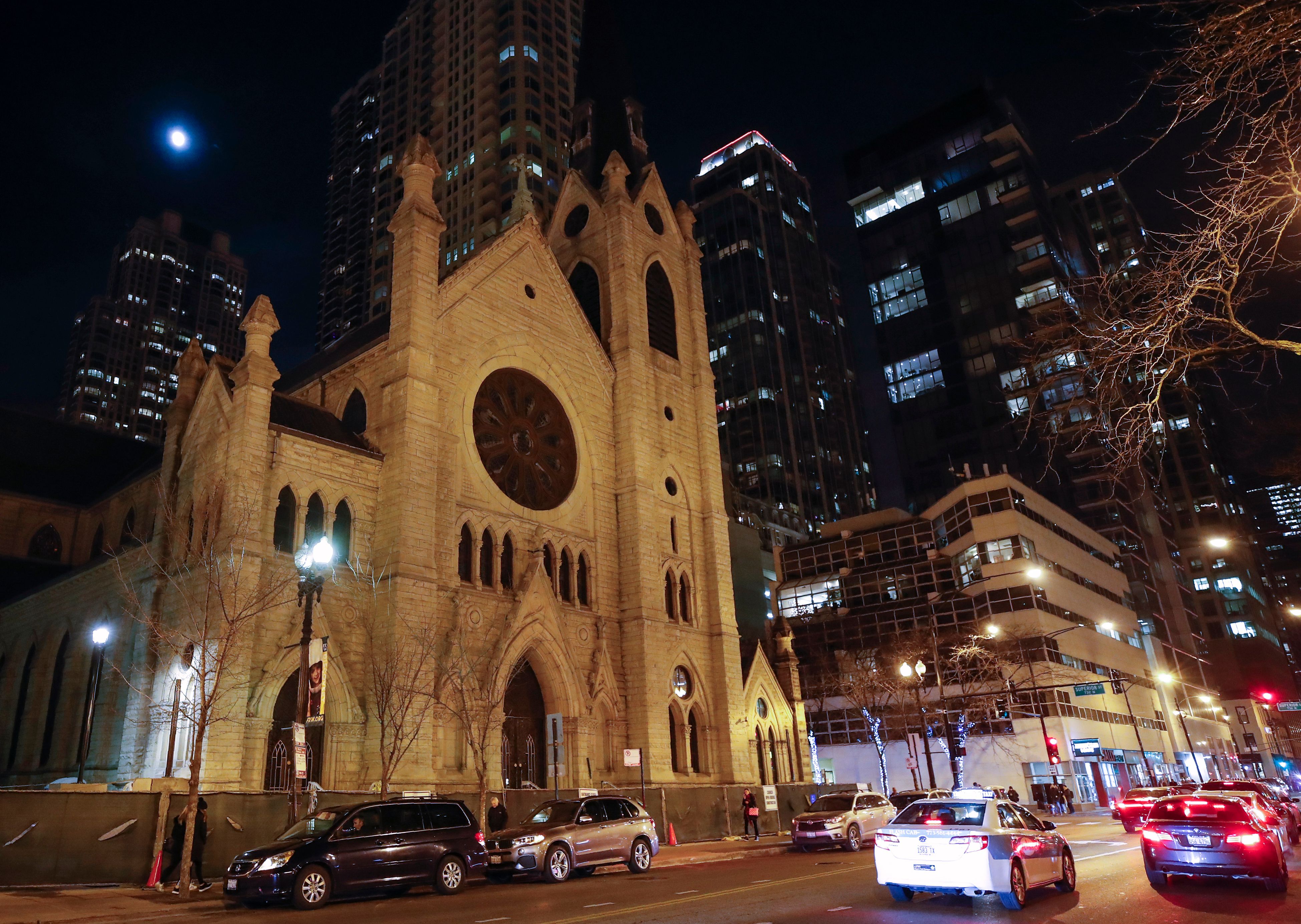 Cars drive past the Holy Name Cathedral in Chicago on Dec. 19, 2018. (Credit: Kamil Krzaczynski / AFP / Getty Images)