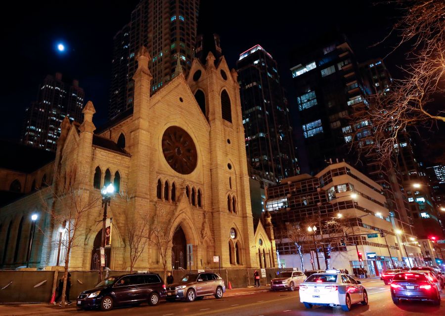 Cars drive past the Holy Name Cathedral in Chicago on Dec. 19, 2018. (Credit: Kamil Krzaczynski / AFP / Getty Images)